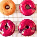 Blueberry glazed donuts on wire rack