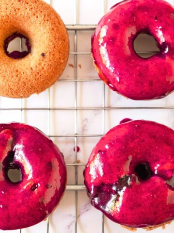 Blueberry glazed donuts on wire rack