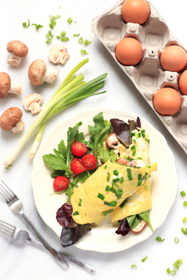 Spinach Mushroom Omelet (Gluten-Free, Dairy-Free) Spinach omelet wraps with salad on a plate.