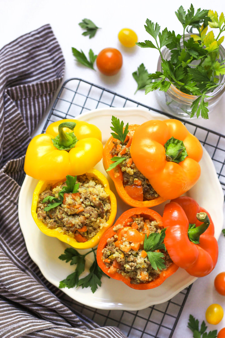 A plate of colorful stuffed bell peppers on a wire rack.