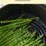 Asparagus stalks in air fryer basket.