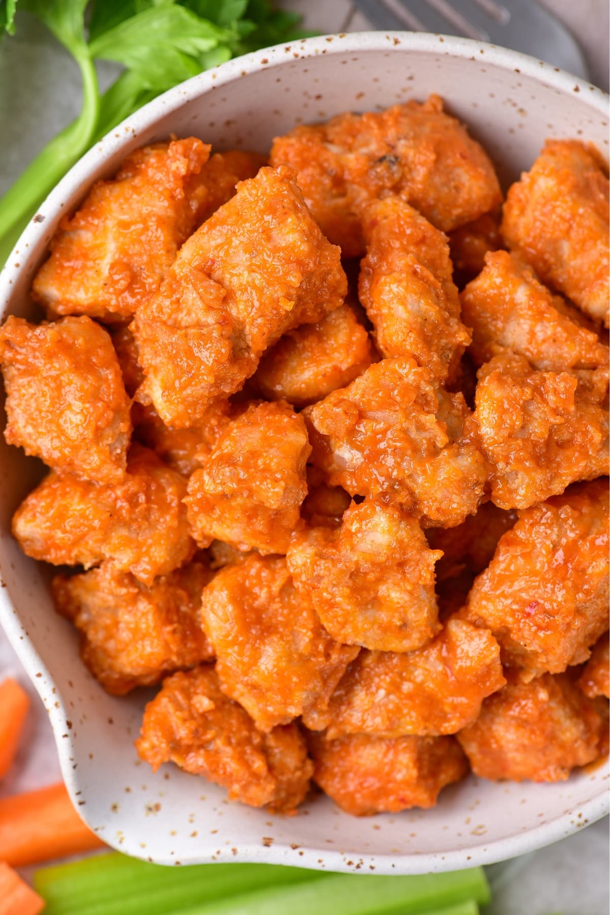 Up close shot of a bowl of buffalo chicken bites.