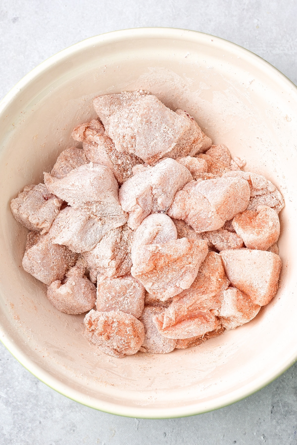 Coated chicken bites in bowl.