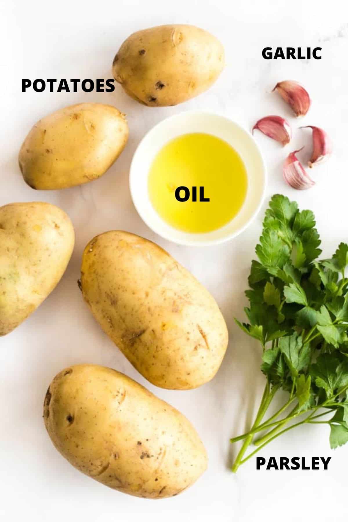 Ingredients for making air fryer hasselback potatoes laid out on marble board.