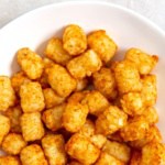A bowl of freshly air fried tater tots.