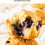 Half eaten blueberry muffin on top of another muffin.
