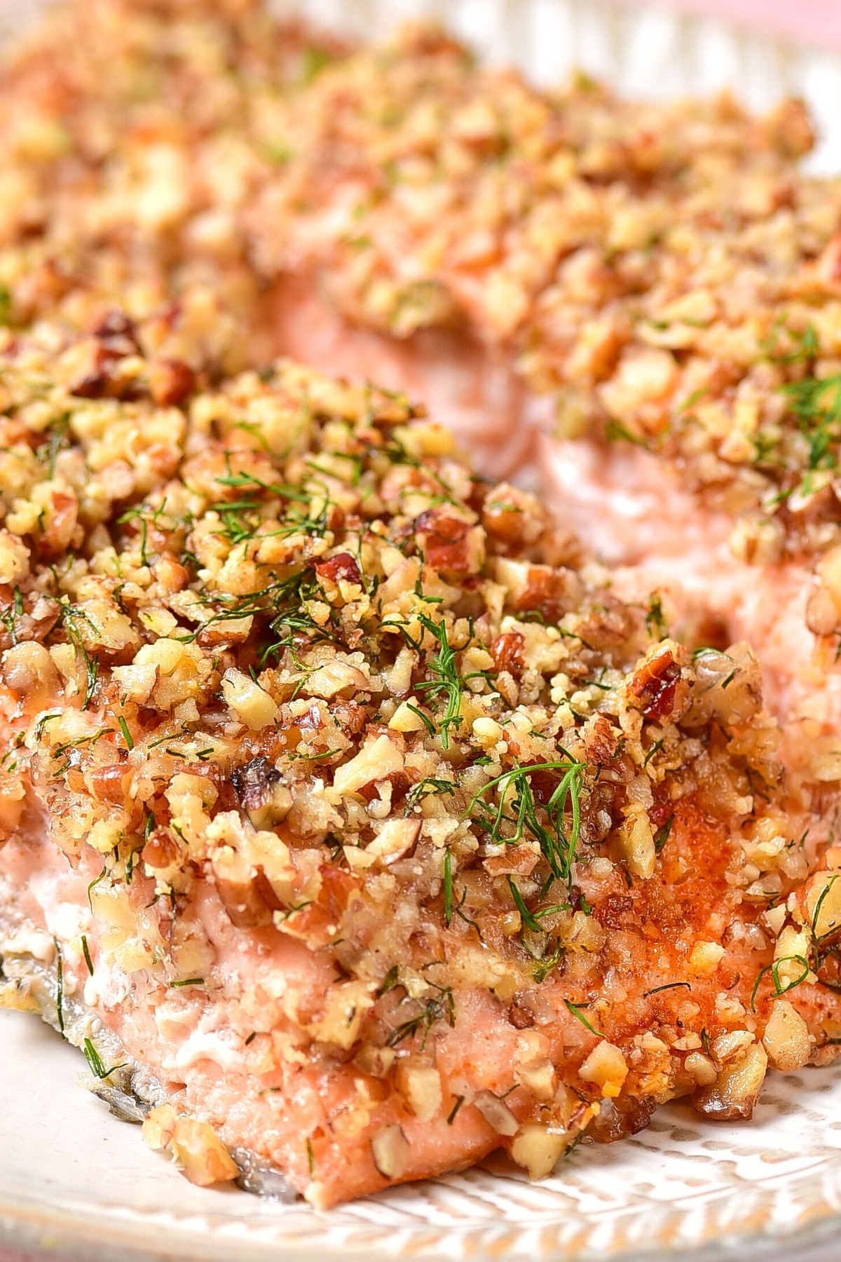Up close shot of texture of almond crusted salmon on plate.