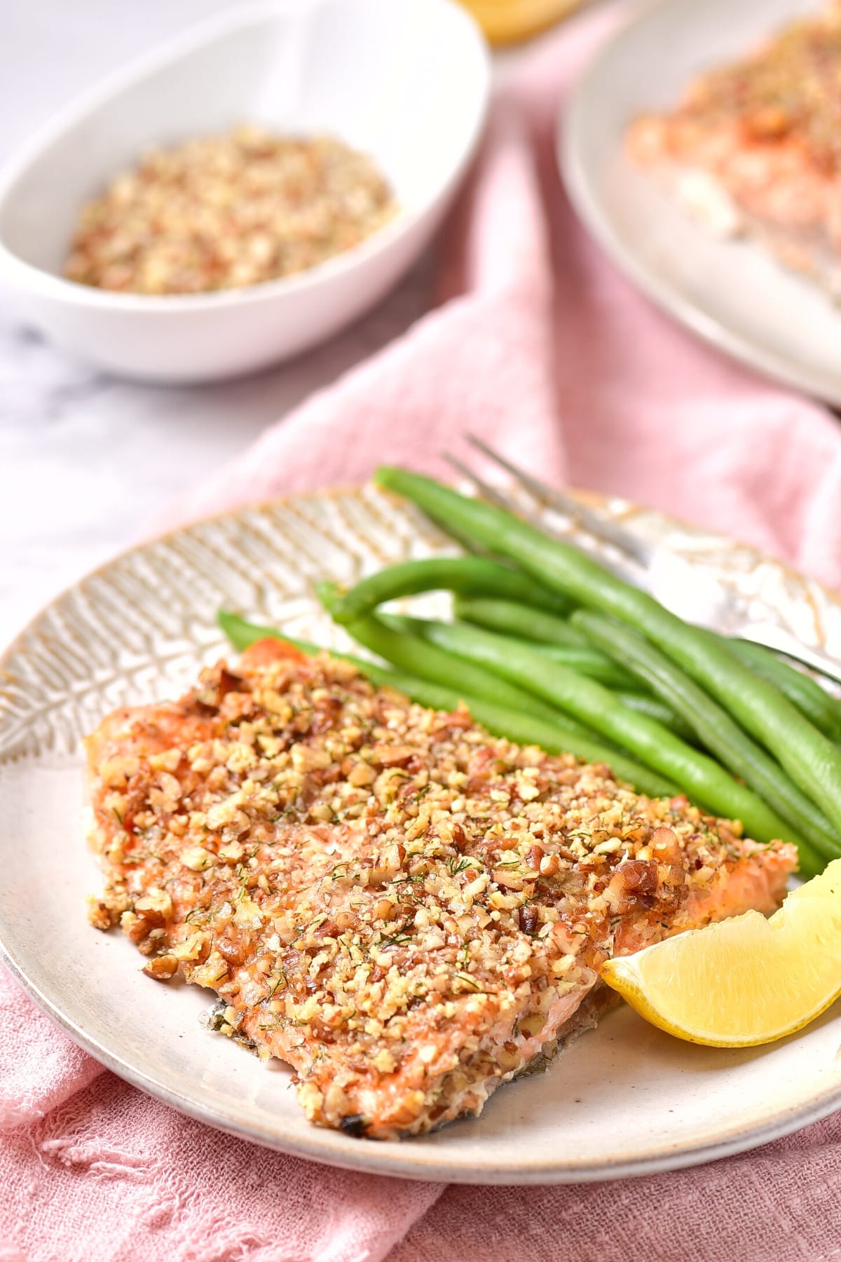 A plate of baked almond meal crusted salmon with green beans.
