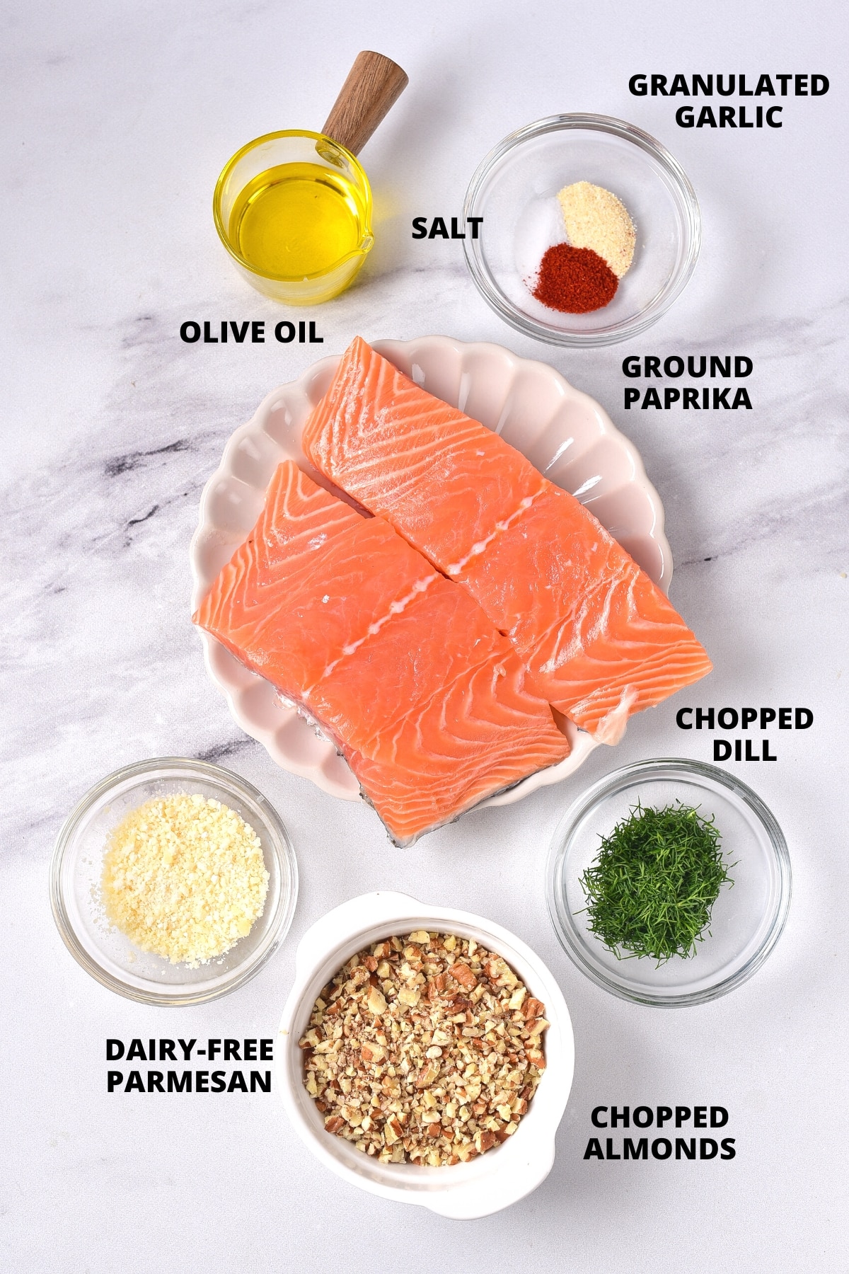 Ingredients for almond crusted salmon recipe laid out on marble board.