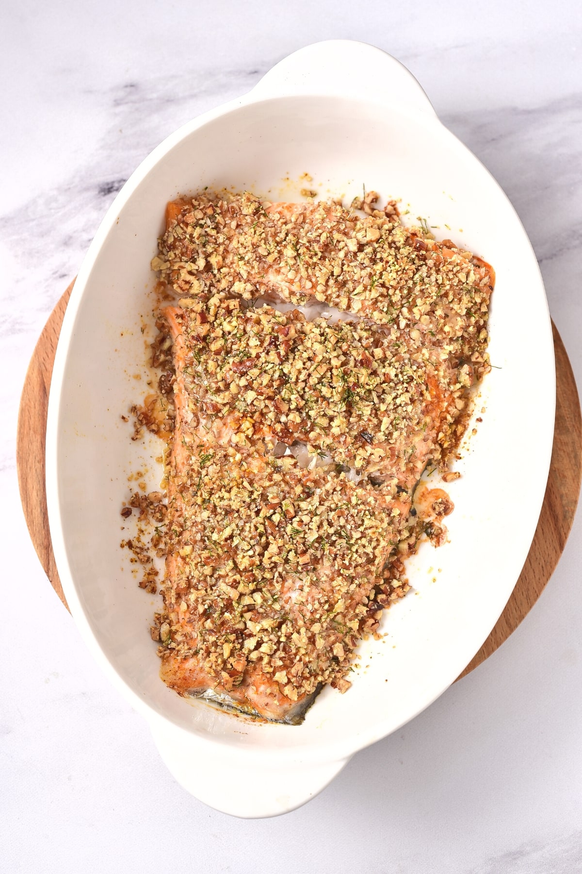 Baked almond crusted salmon in white bowl