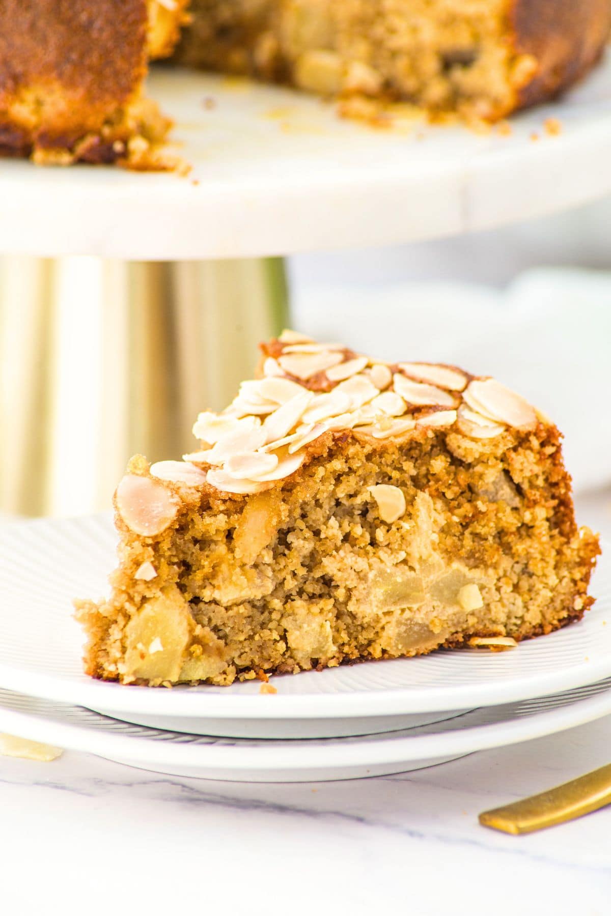 A slice of apple almond flour cake on small plate