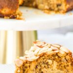 Up close view of a slice of almond flour apple cake on white plate