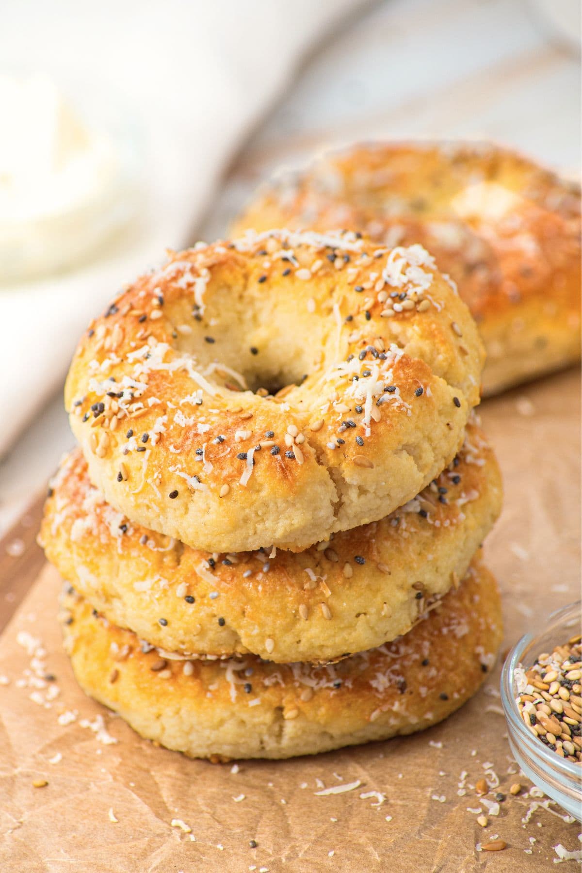 A stack of almond flour bagels on parchment paper.