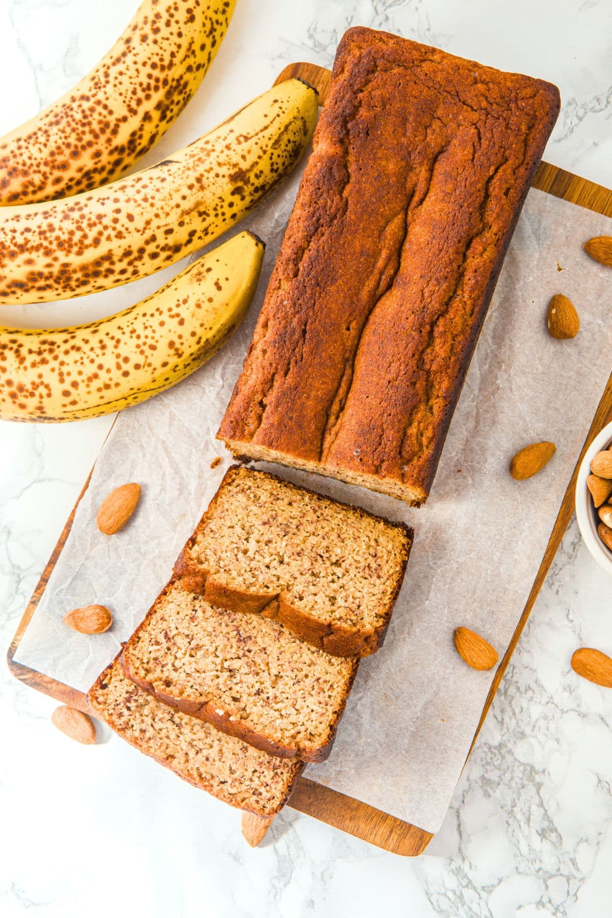 Top down view of a sliced loaf of banana bread with almond flour