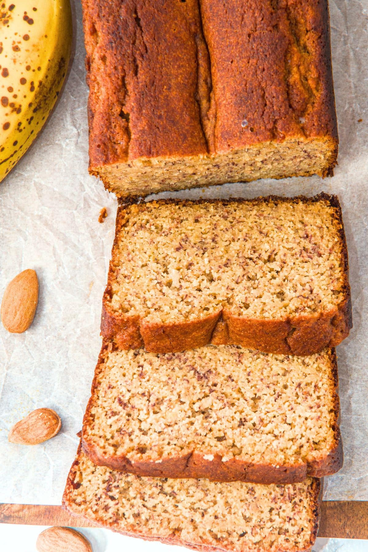 Sliced almond flour banana loaf on parchment paper