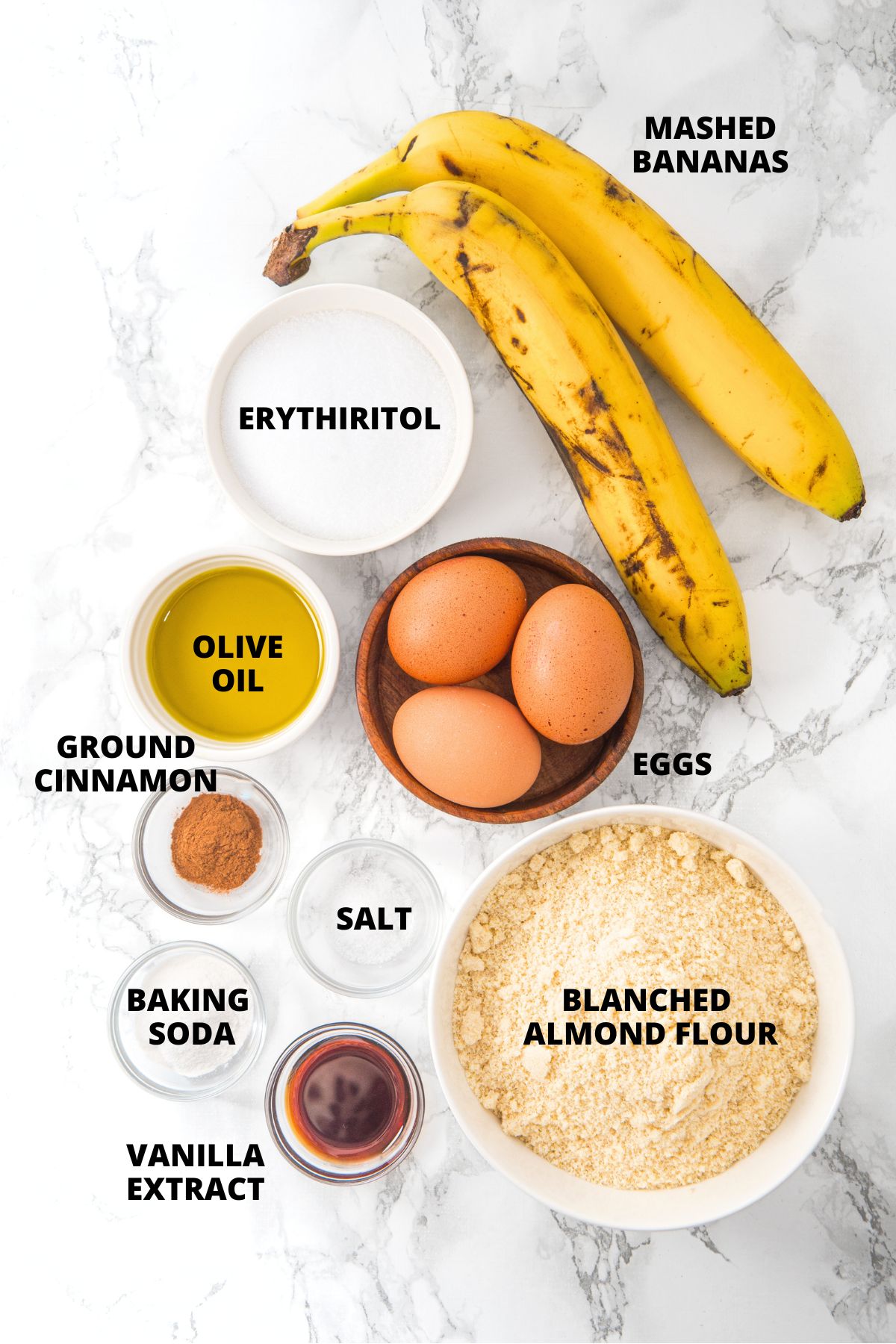 Ingredients for almond flour banana bread recipe laid out on marble board.