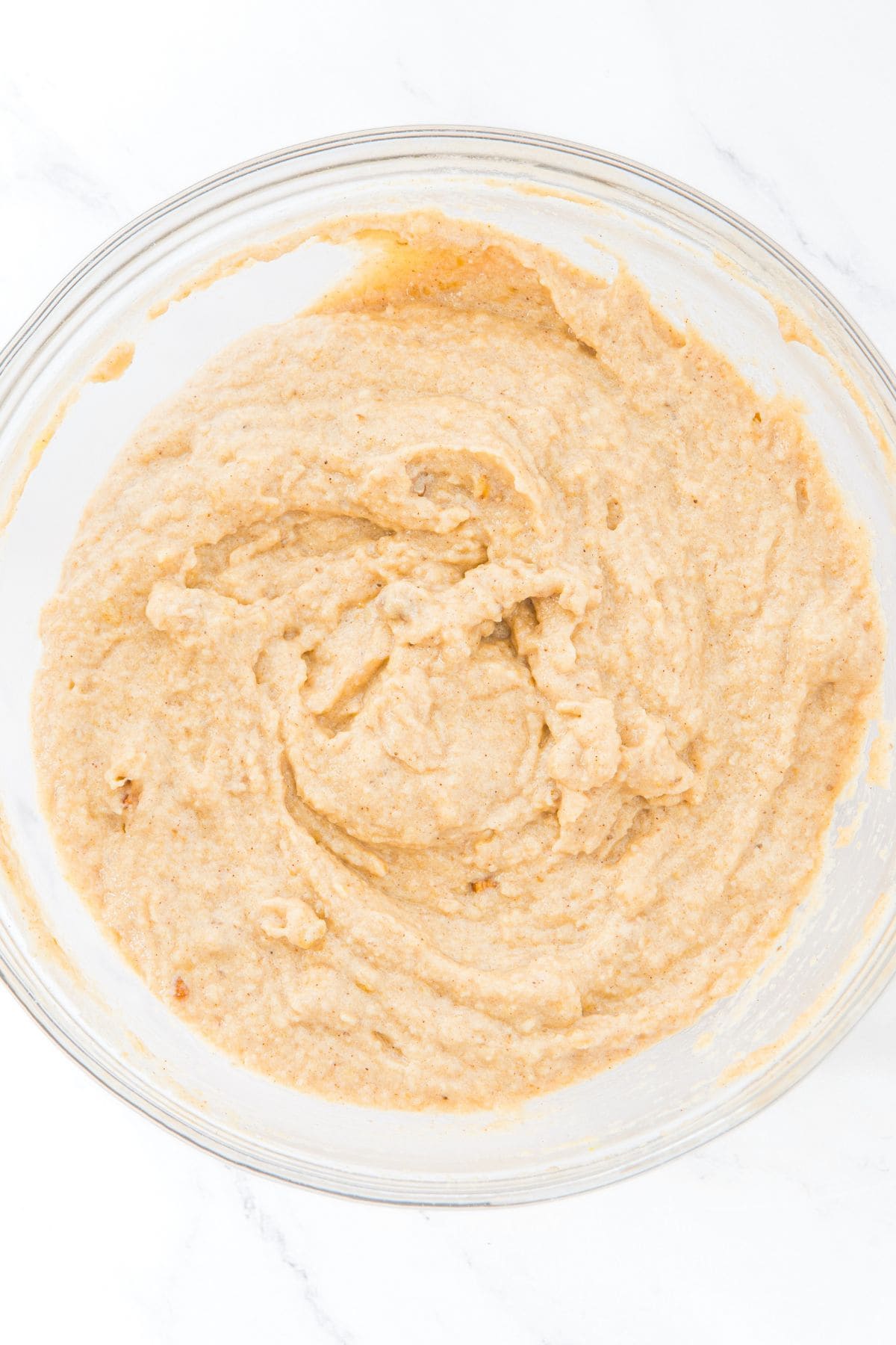 Pale brown batter in glass mixing bowl