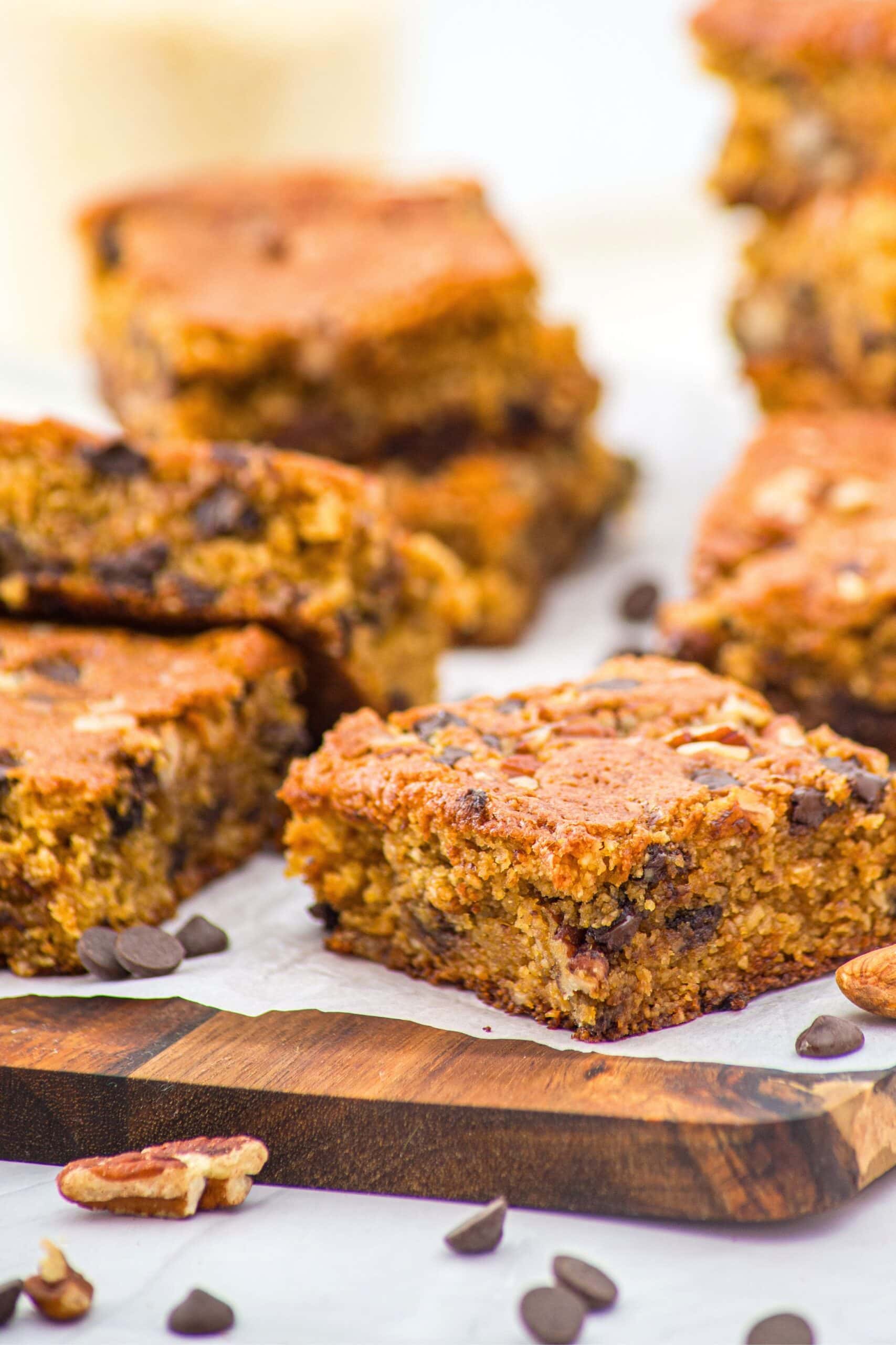 Up close view of chocolate chip almond flour blondies on parchment-lined board