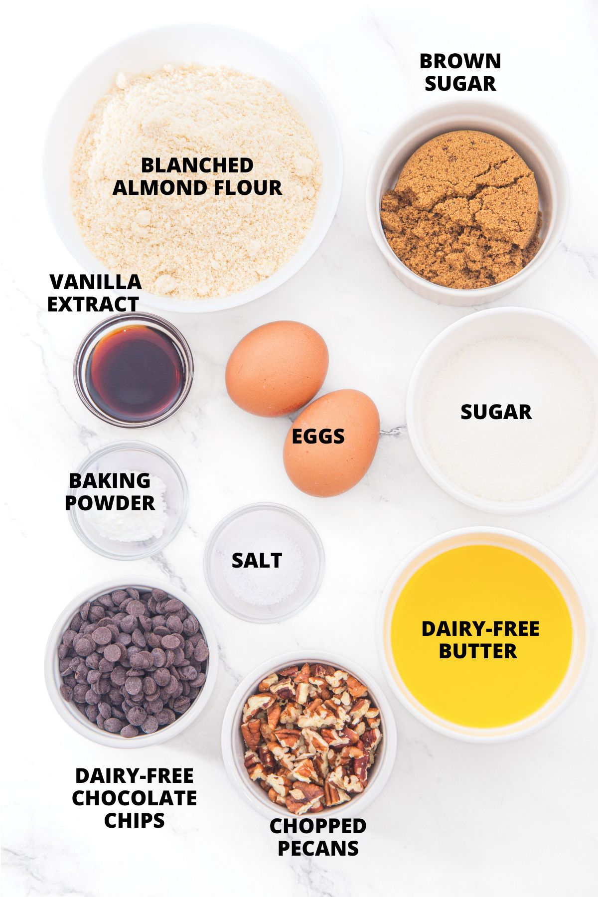 Ingredients for almond flour blondies recipe laid out on marble board.