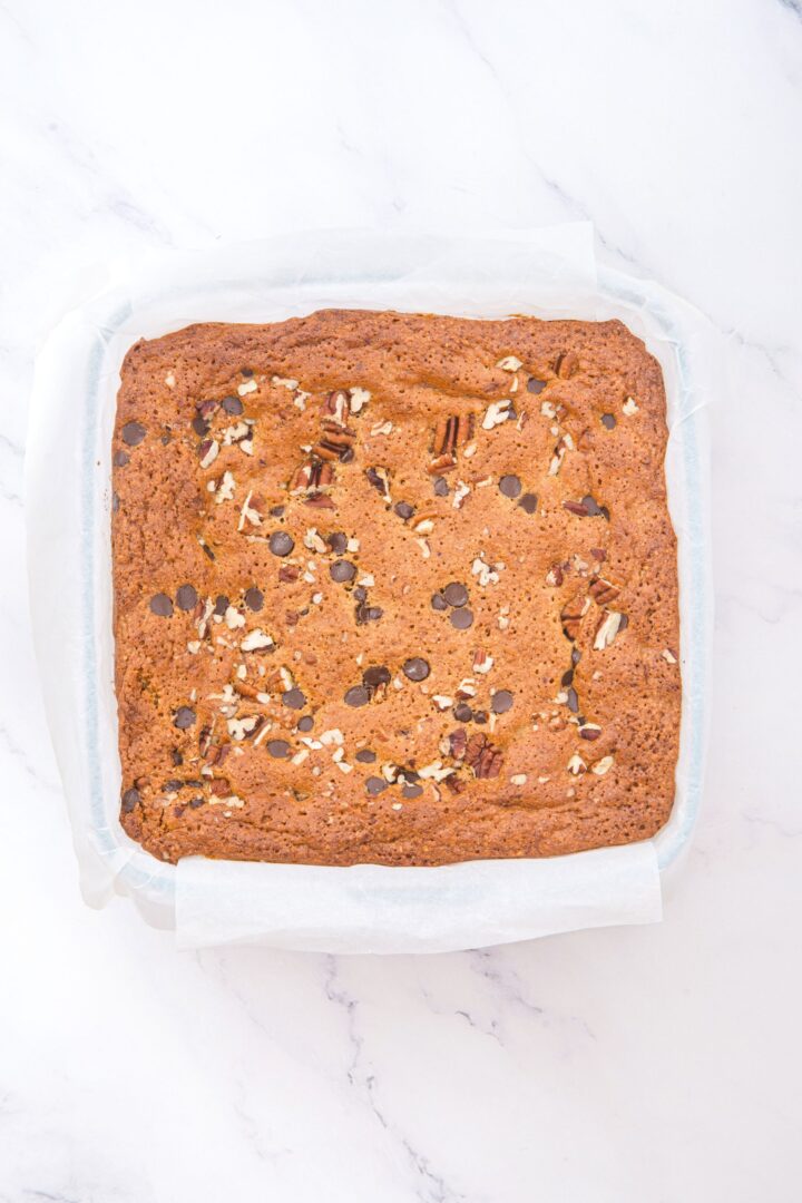 Freshly baked blondies in glass pan.