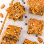Top down view of almond flour blondies on parchment-lined wooden board.