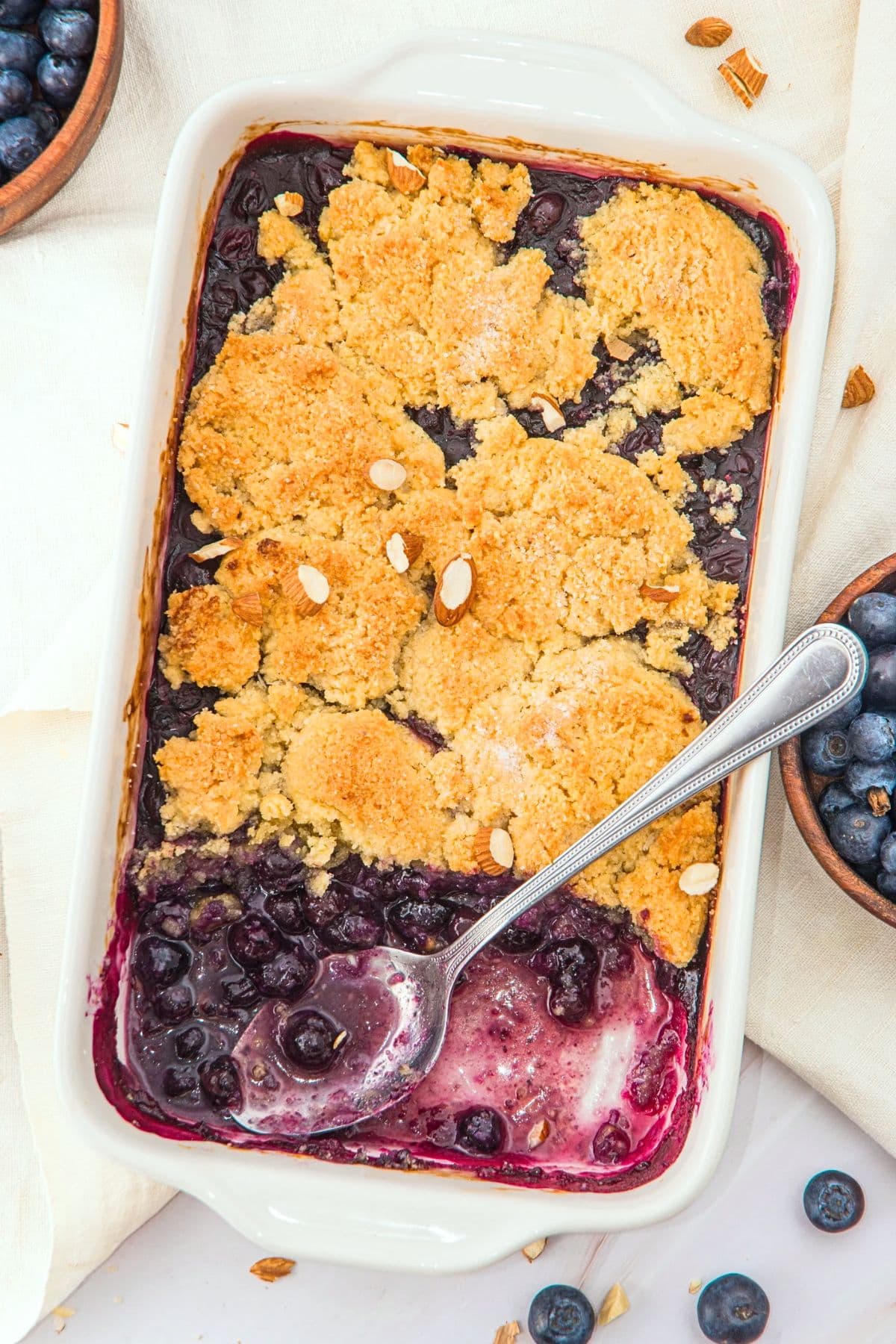 Top down view of half-eaten almond flour blueberry cobbler.