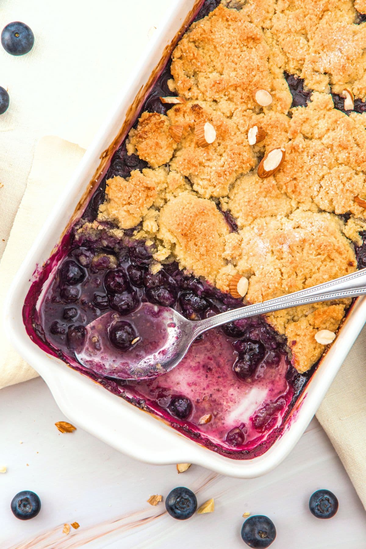 Top down view of half-eaten almond flour blueberry cobbler.