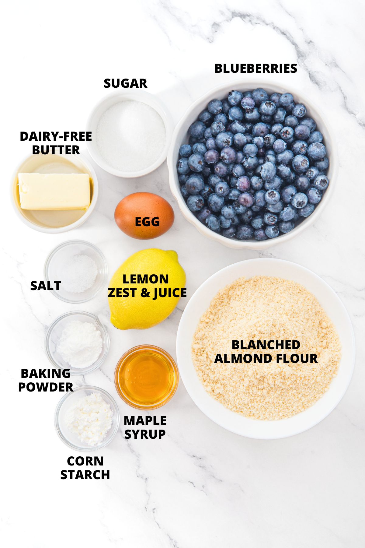 Ingredients for almond flour blueberry cobbler recipe laid out on marble board.