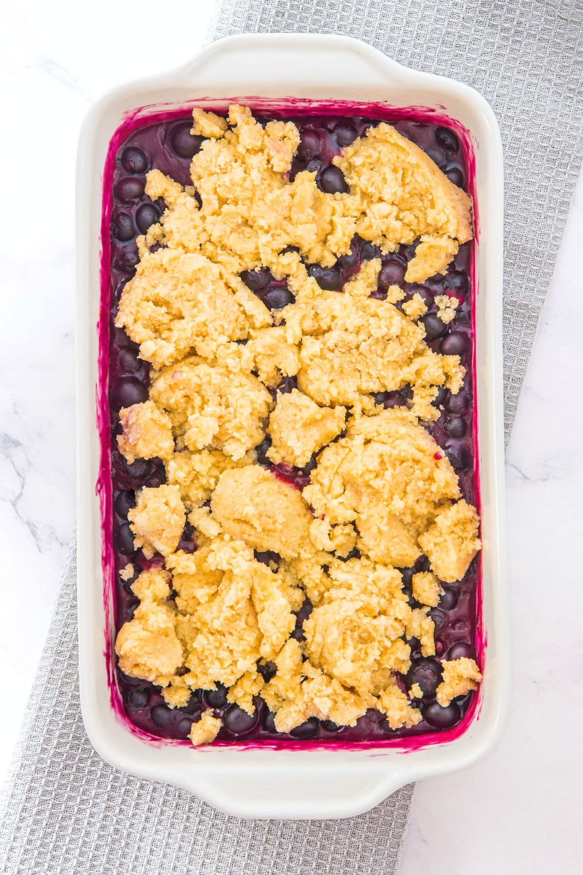 Cobbler dough on top of baked blueberry filling
