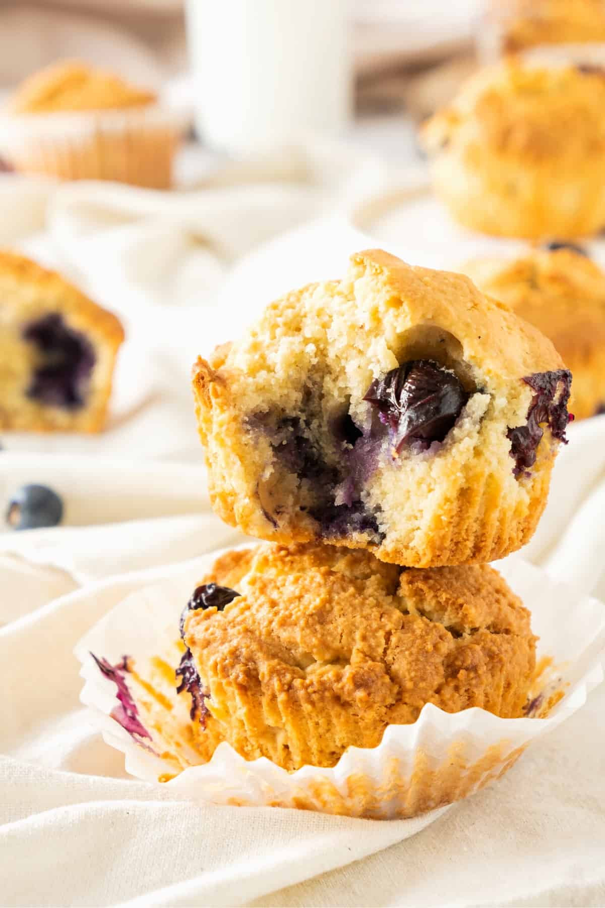 Two blueberry almond flour muffins stacked on top of each other. 