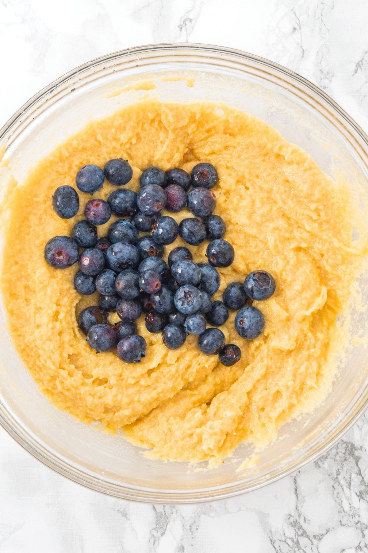 Fresh blueberries on top of muffin batter