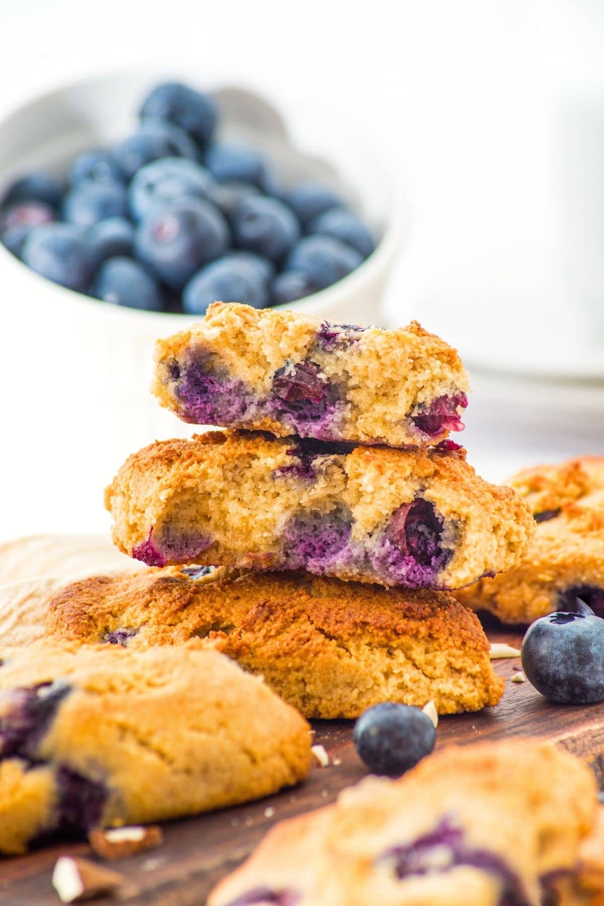 A stack of blueberry almond flour scones on wooden board.