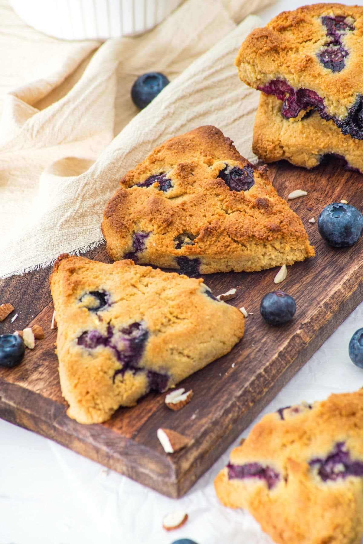 Almond flour blueberry scones on a wooden board.