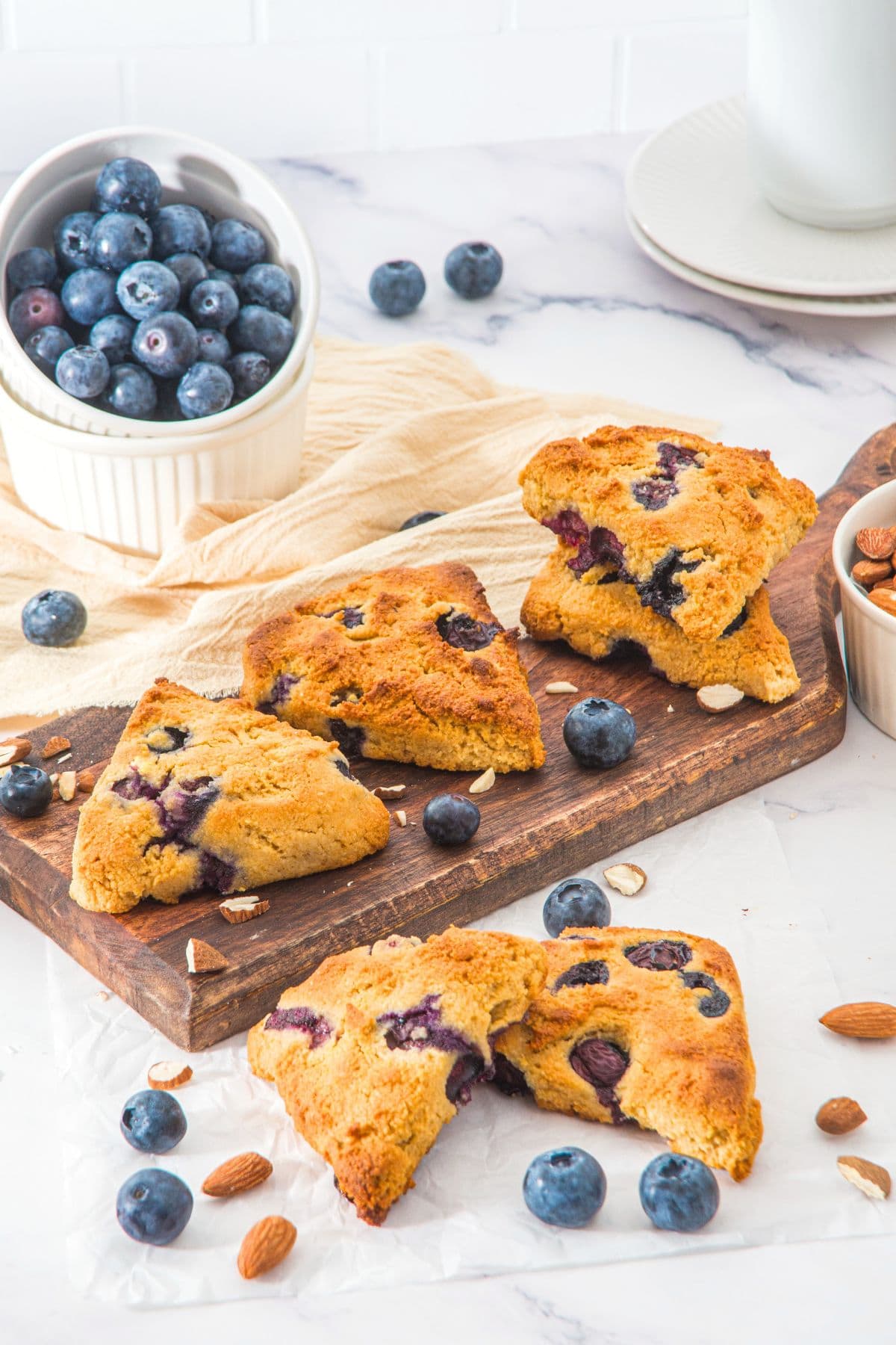 Almond flour scones with blueberries on wooden board.