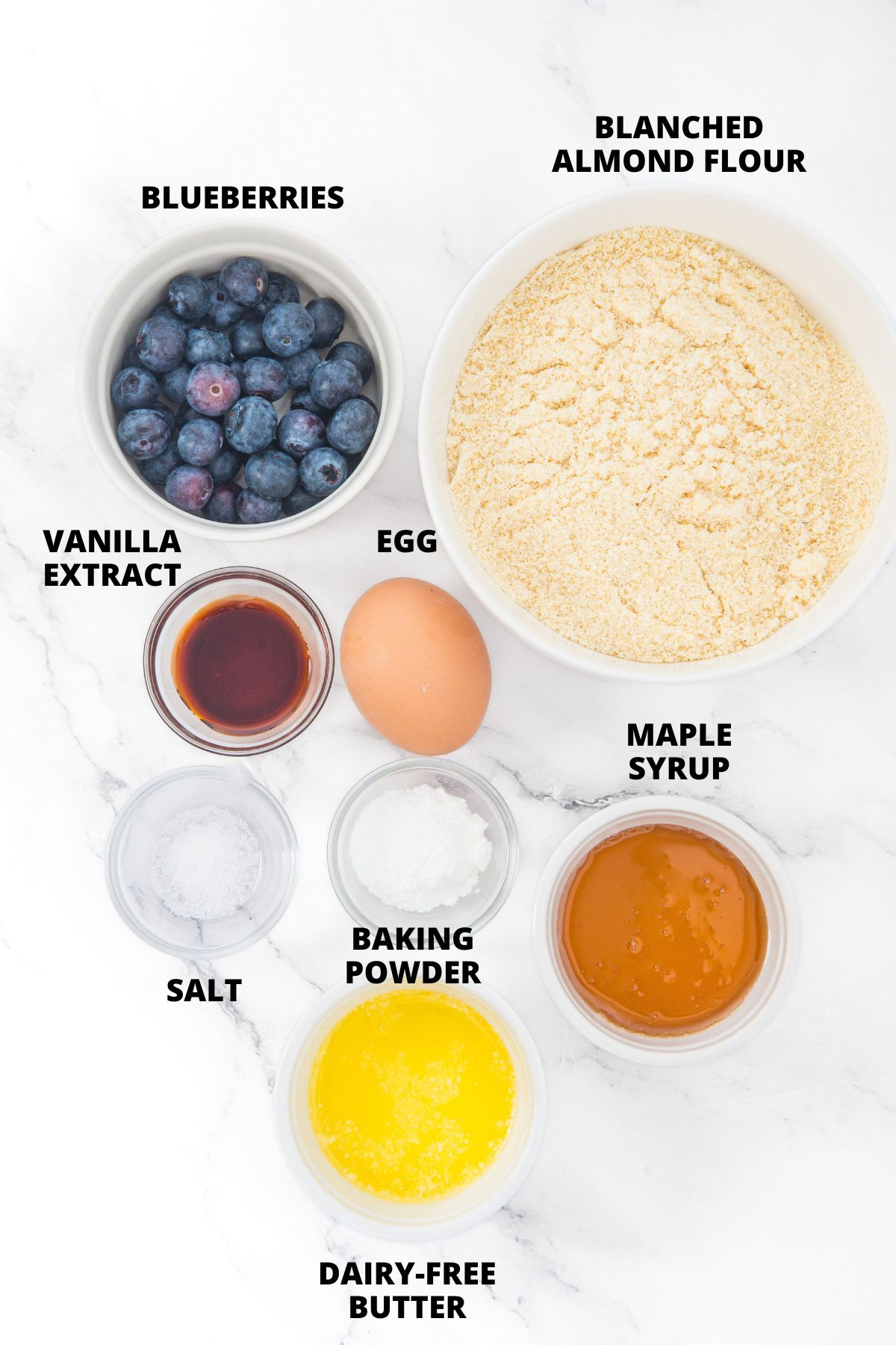Ingredients for almond flour blueberry scones recipe laid out on marble board.