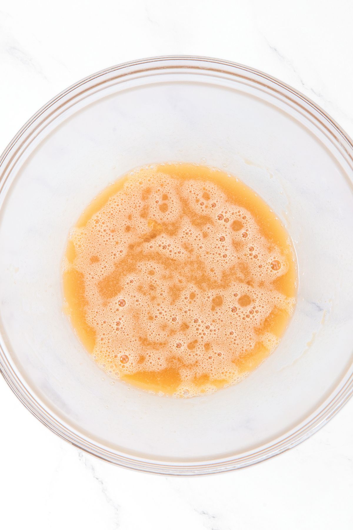 Yellow liquid mixture in glass bowl