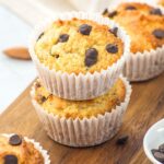 A stack of almond flour chocolate chip muffins on wooden board