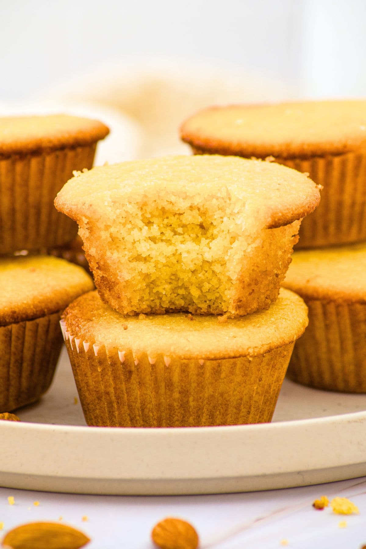 A stack of half-eaten corn muffins with almond flour