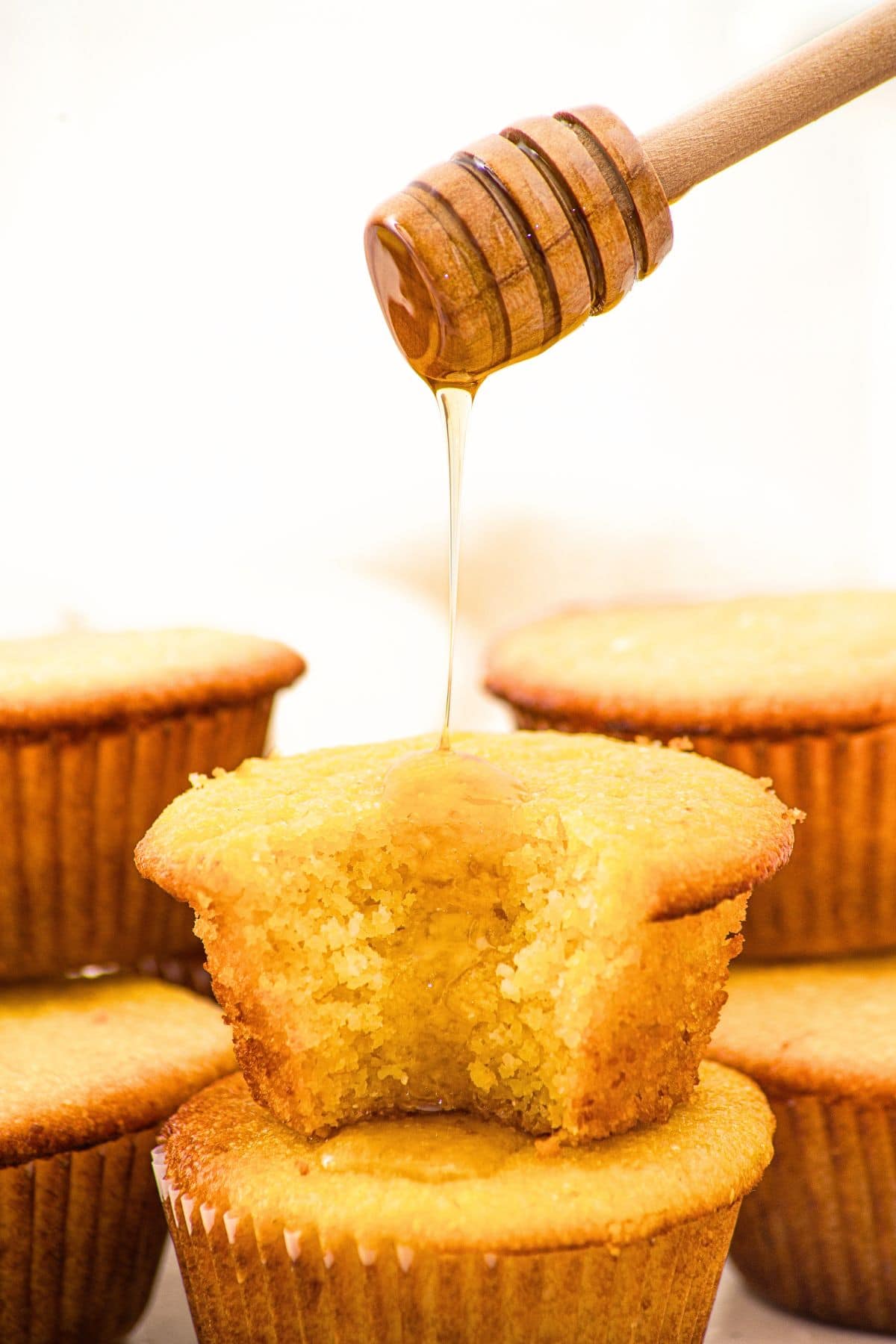 Drizzling honey over almond flour cornbread muffins