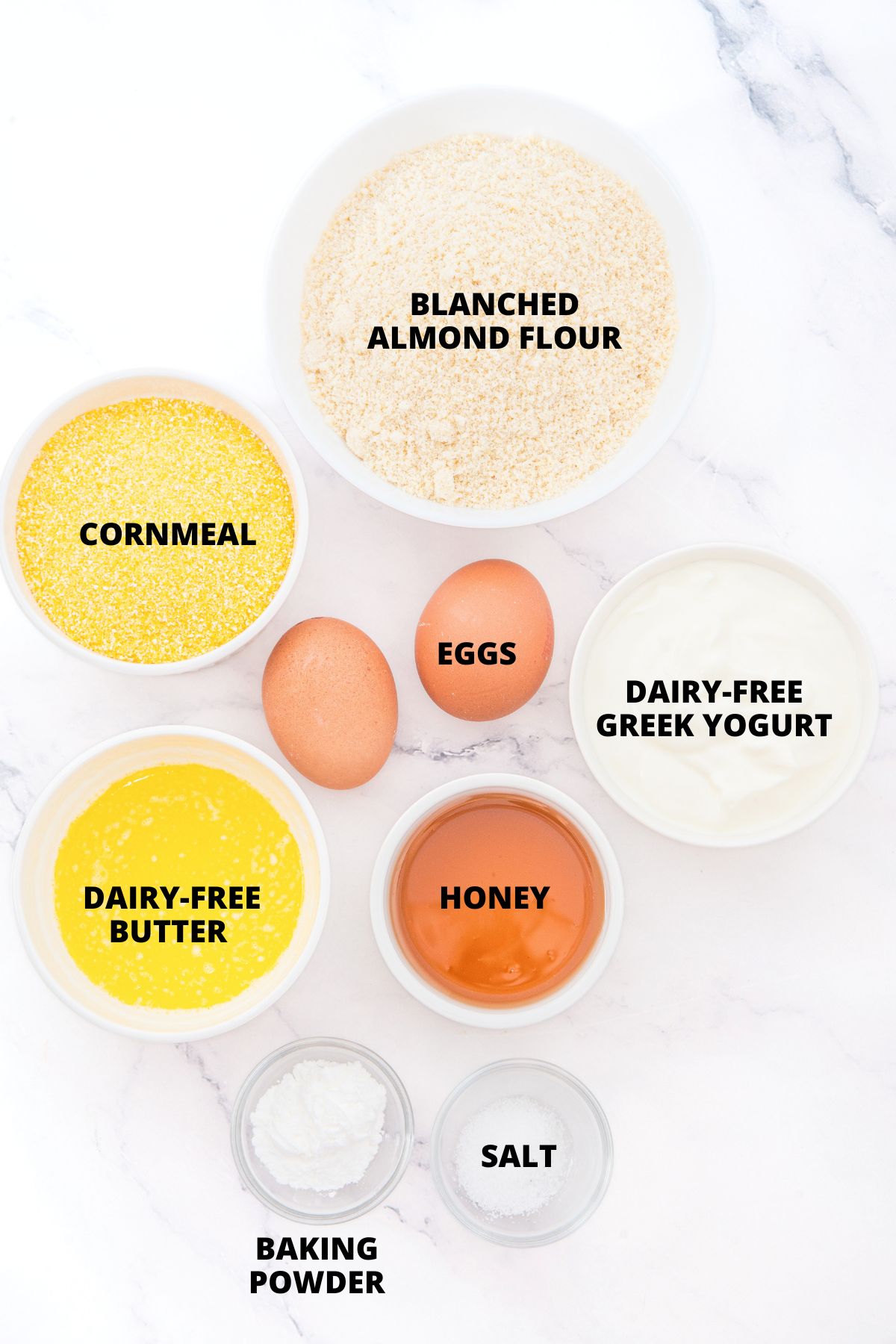 Ingredients for almond flour corn muffins recipe laid out on marble board