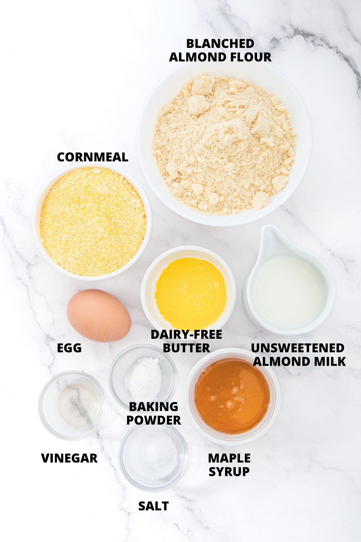 Ingredients for almond flour cornbread recipe laid out on marble board.