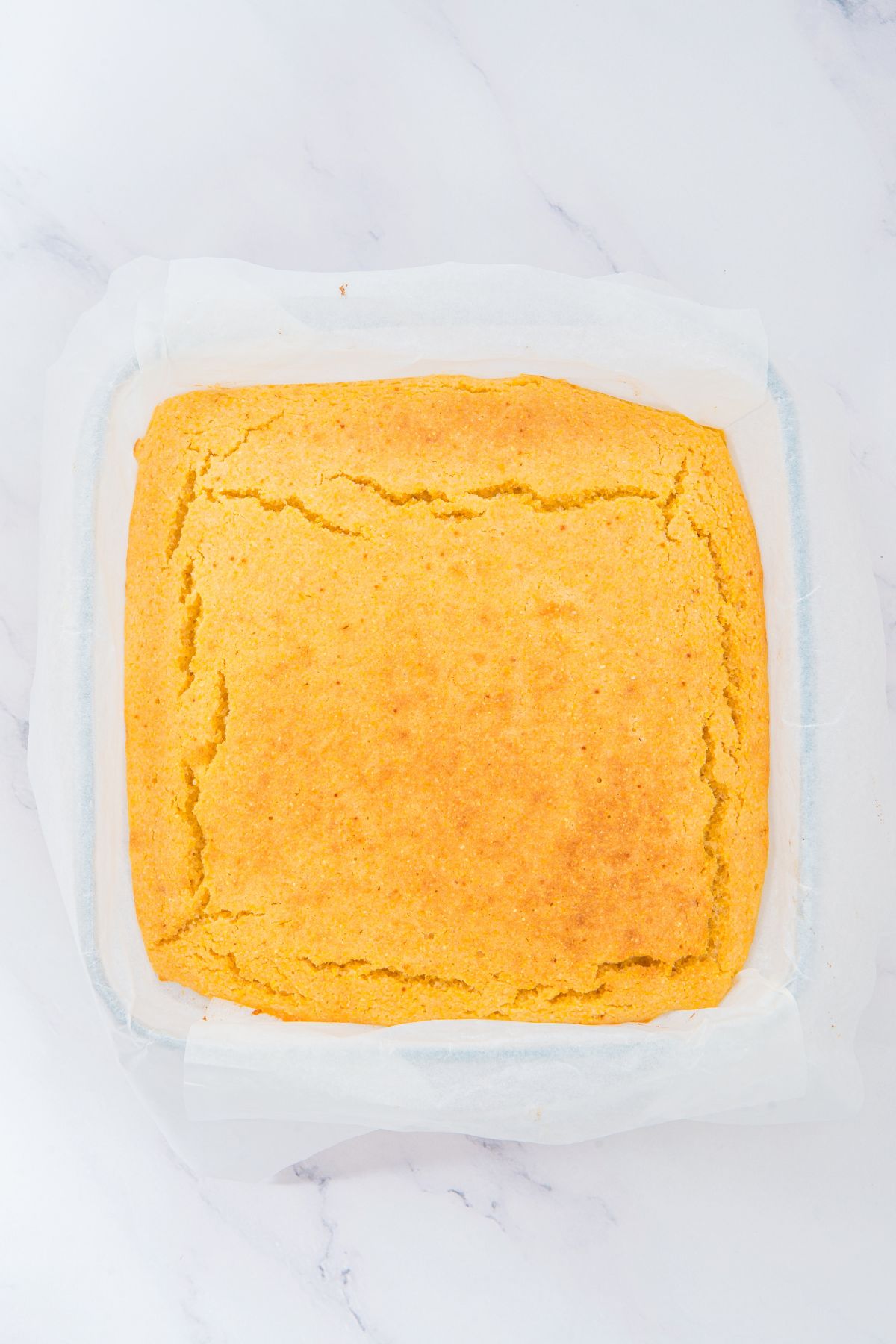 Baked cornbread in parchment-lined baking pan