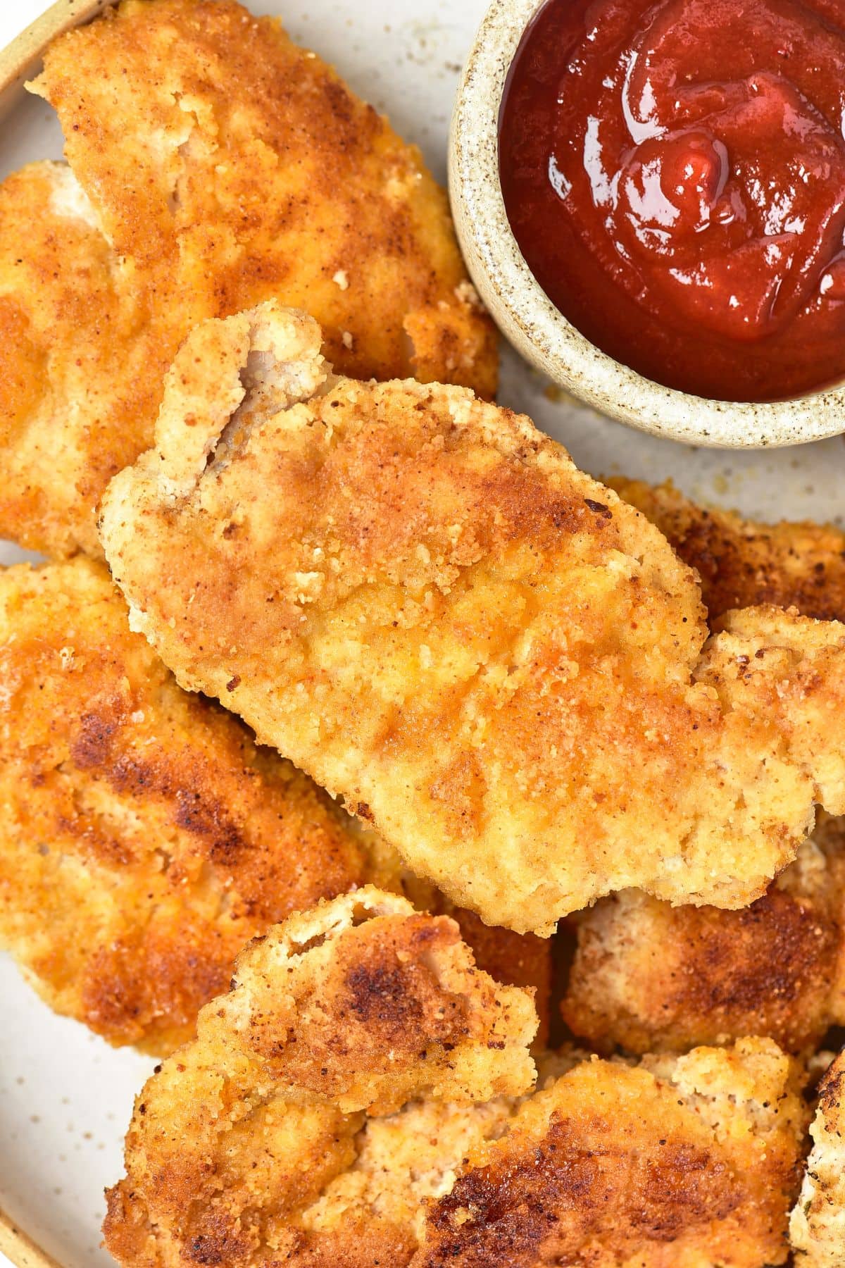 Up close view of pieces of fried chicken with almond flour