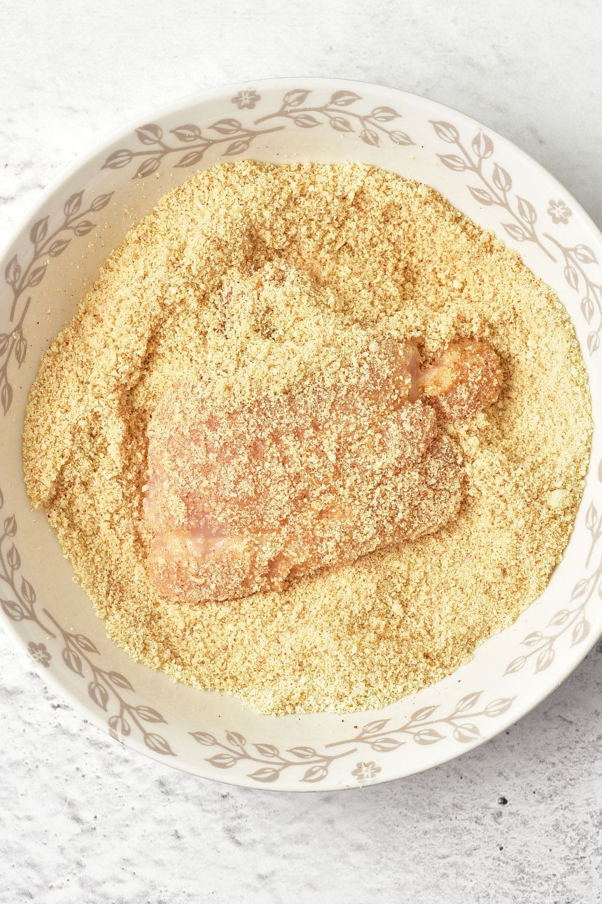 Coating chicken thighs in almond flour mixture