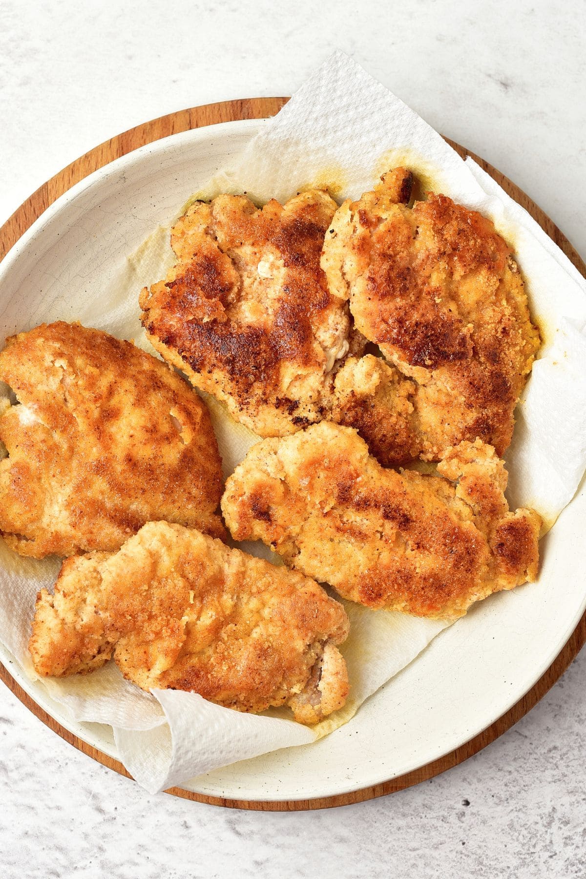 Pieces of almond flour fried chicken on paper towels
