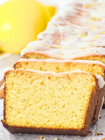 Sliced almond flour lemon loaf on parchment paper.