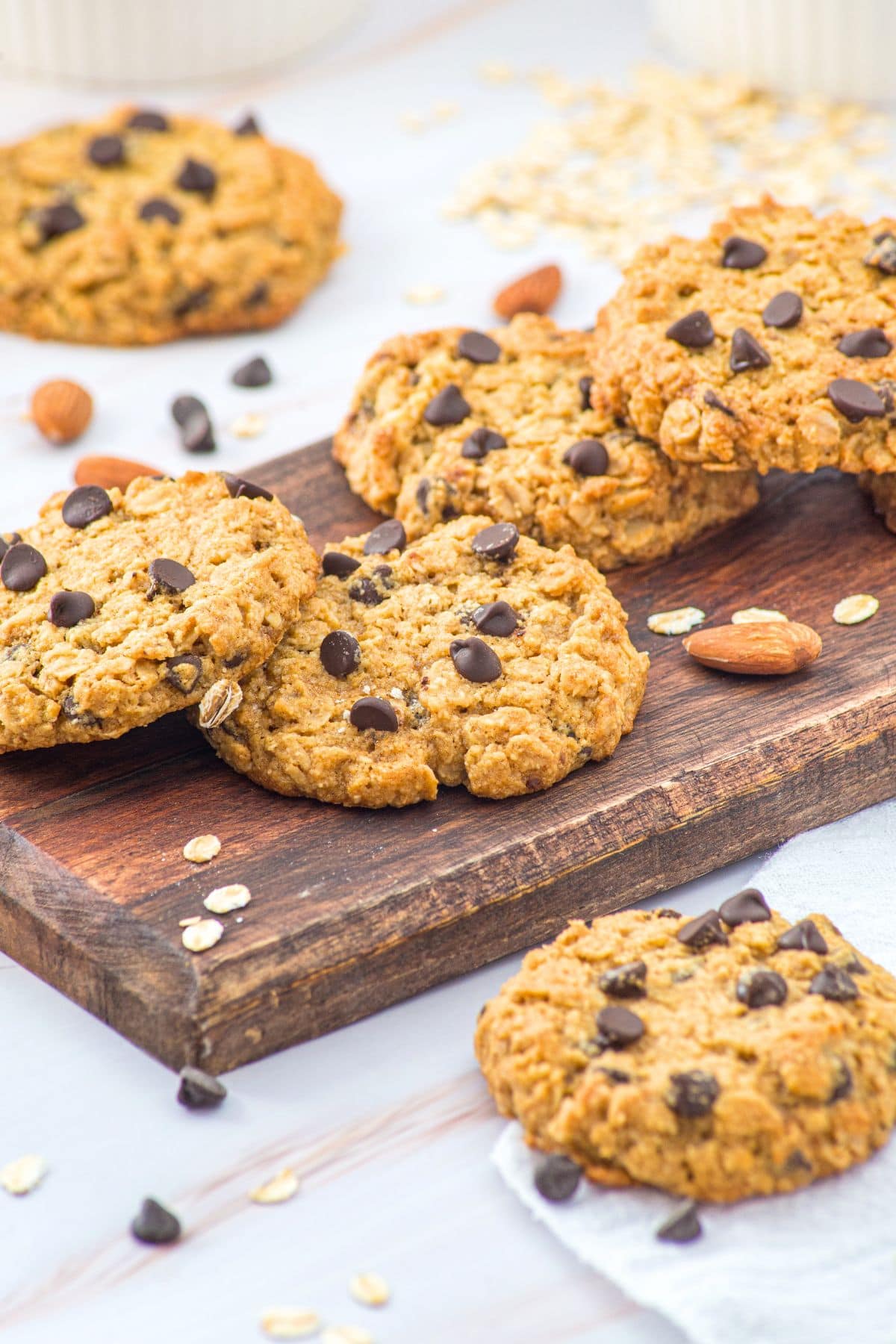 Almond flour oatmeal cookies with chocolate chips on wooden board.