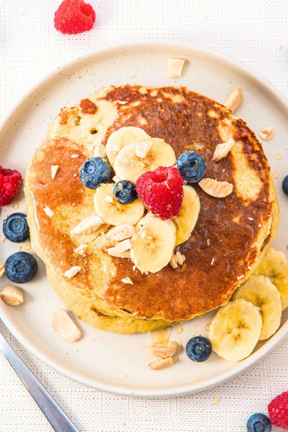 Top down view of a plateful of almond flour and banana pancakes on plate.