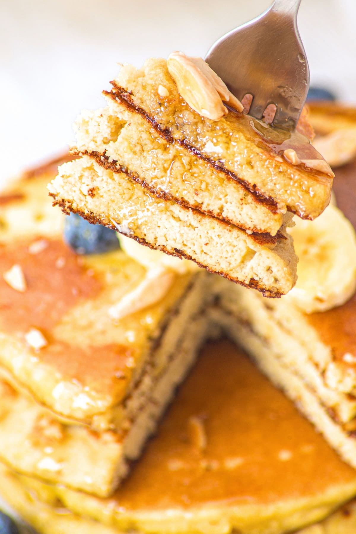 Holding up a forkful of half-eaten pancakes