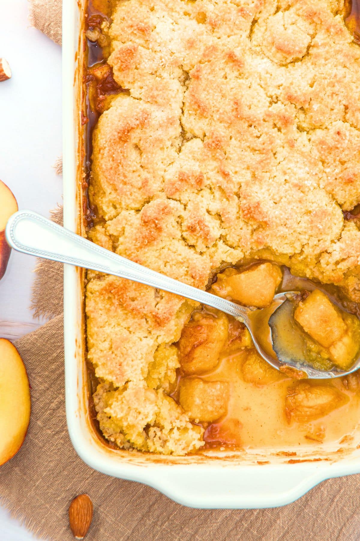 Almond Flour Peach Cobbler (Gluten-Free, Dairy-Free) Top down view of baking dish with almond flour peach cobbler.